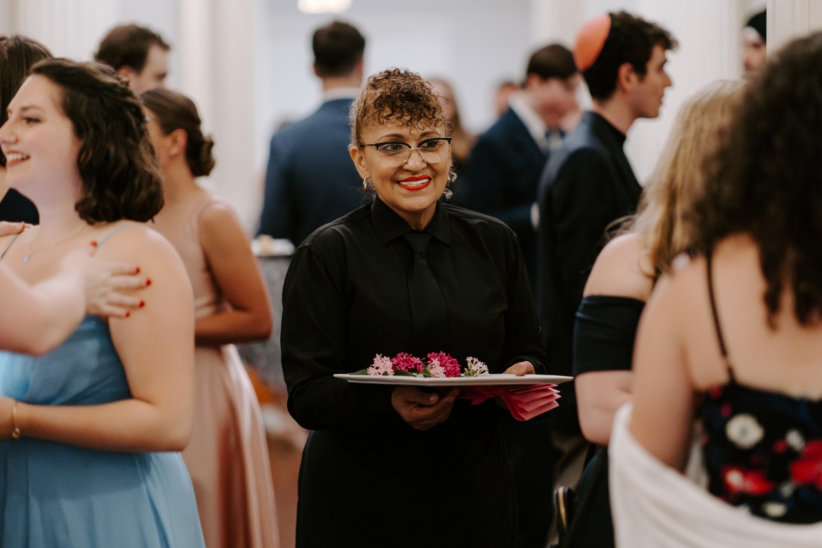 paramount events in-house staff at a wedding holding a plate of small bites