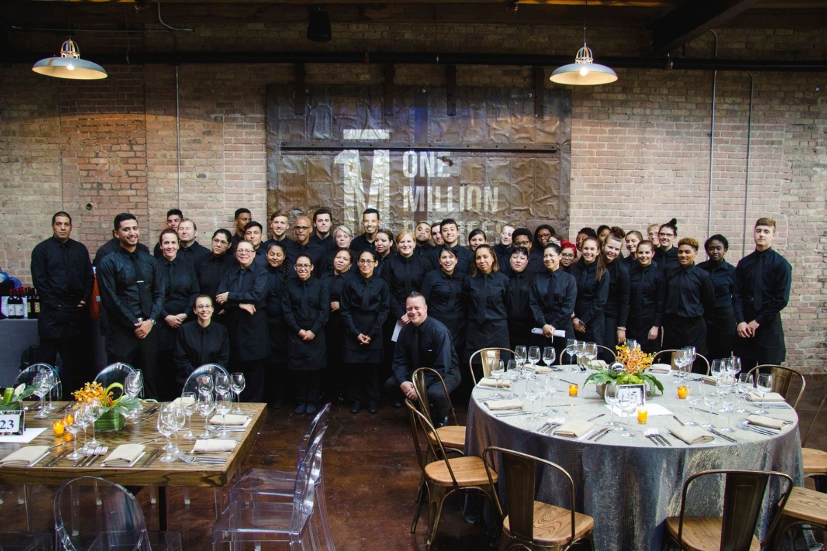 group photo of Paramount Events' in-house full service catering staff at an old brick venue