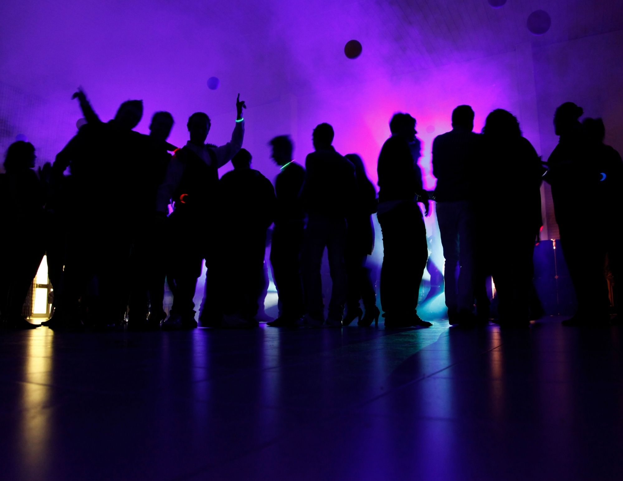 a dance floor lit with ambient lighting for kids and adults at a catering event