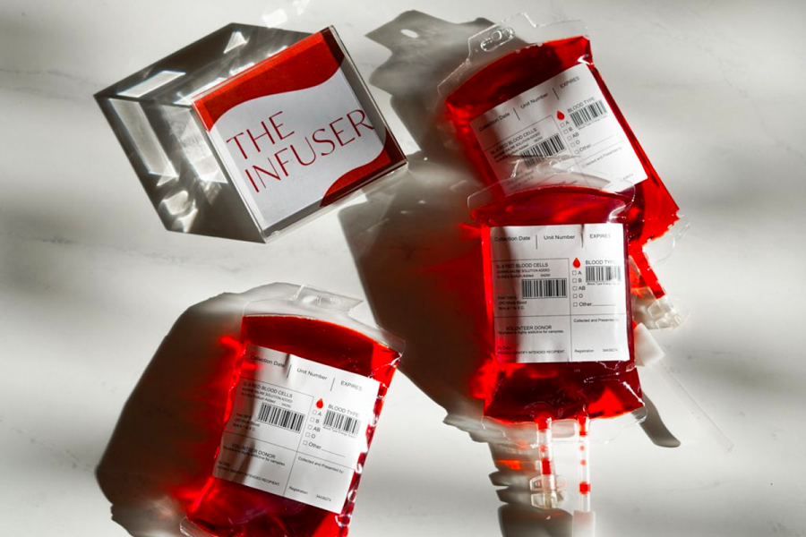 Our Halloween Infuser Cocktail: Tequila, Blood Orange Juice, Lime, Smoked Honey Syrup Served in a Blood Bag with a Straw